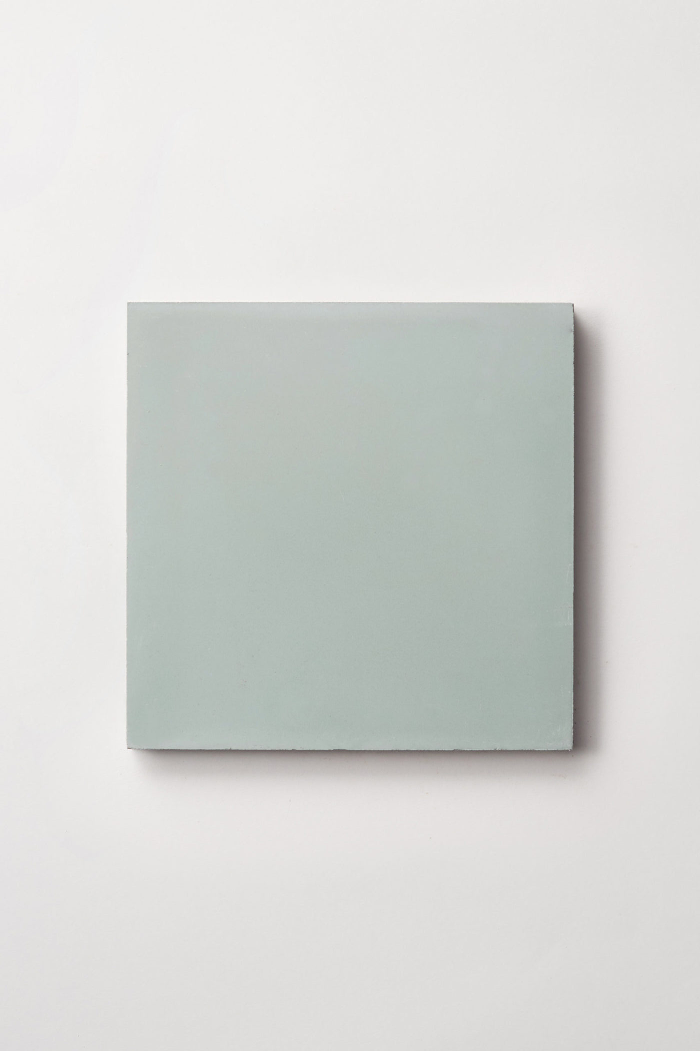 a green square tile on a white background.