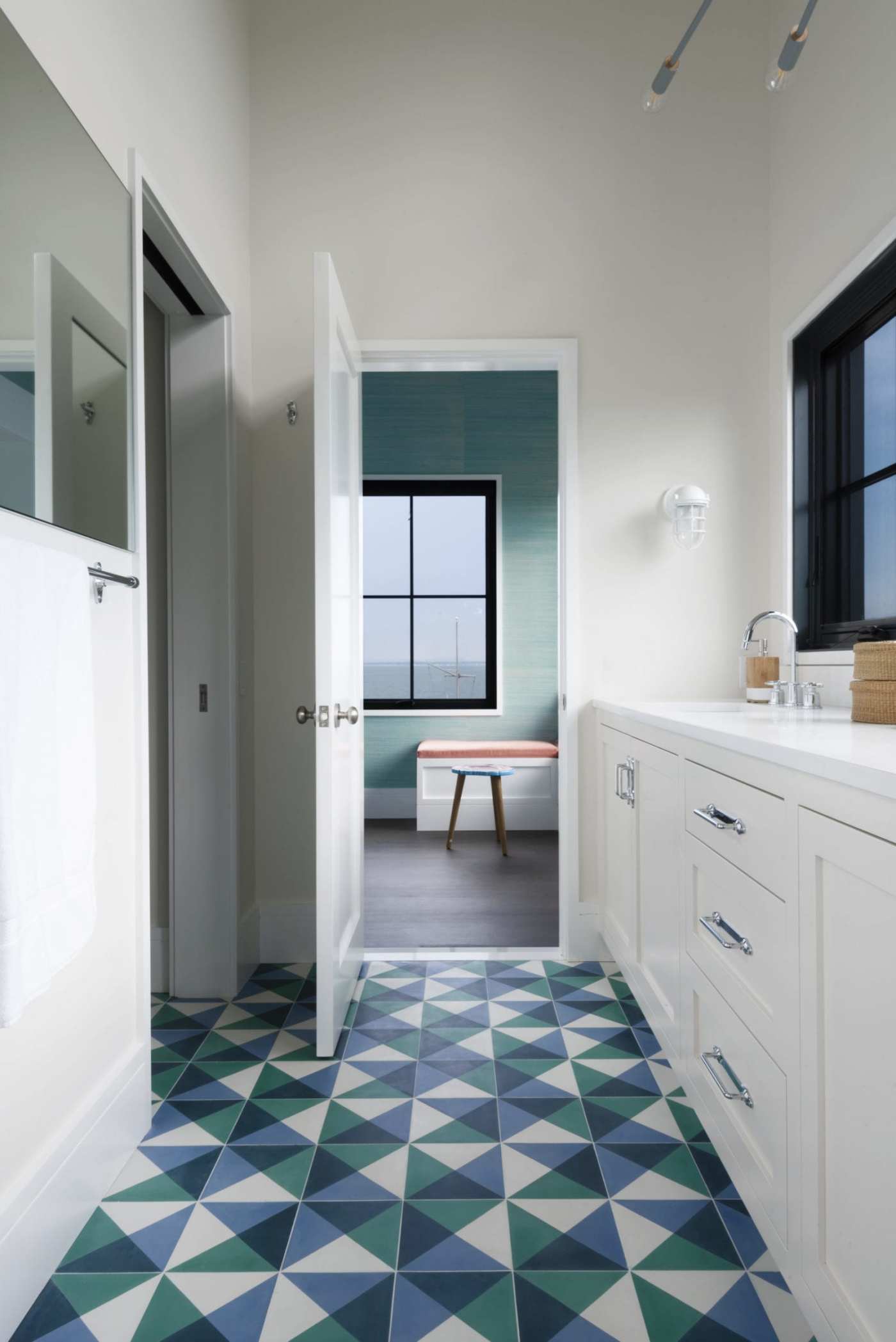 a bathroom with a blue and green tiled floor.