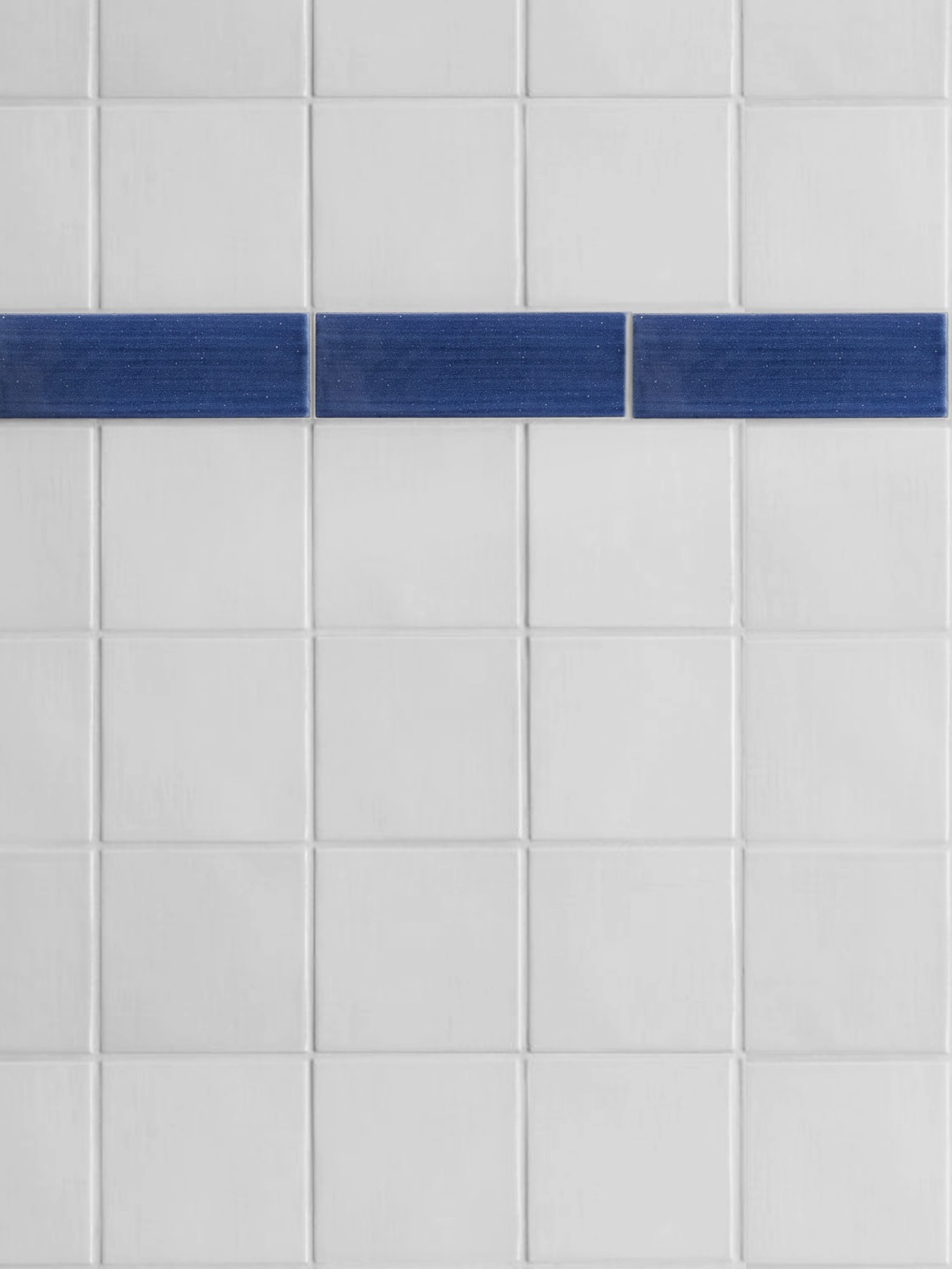 a white tile with a blue stripe on it.