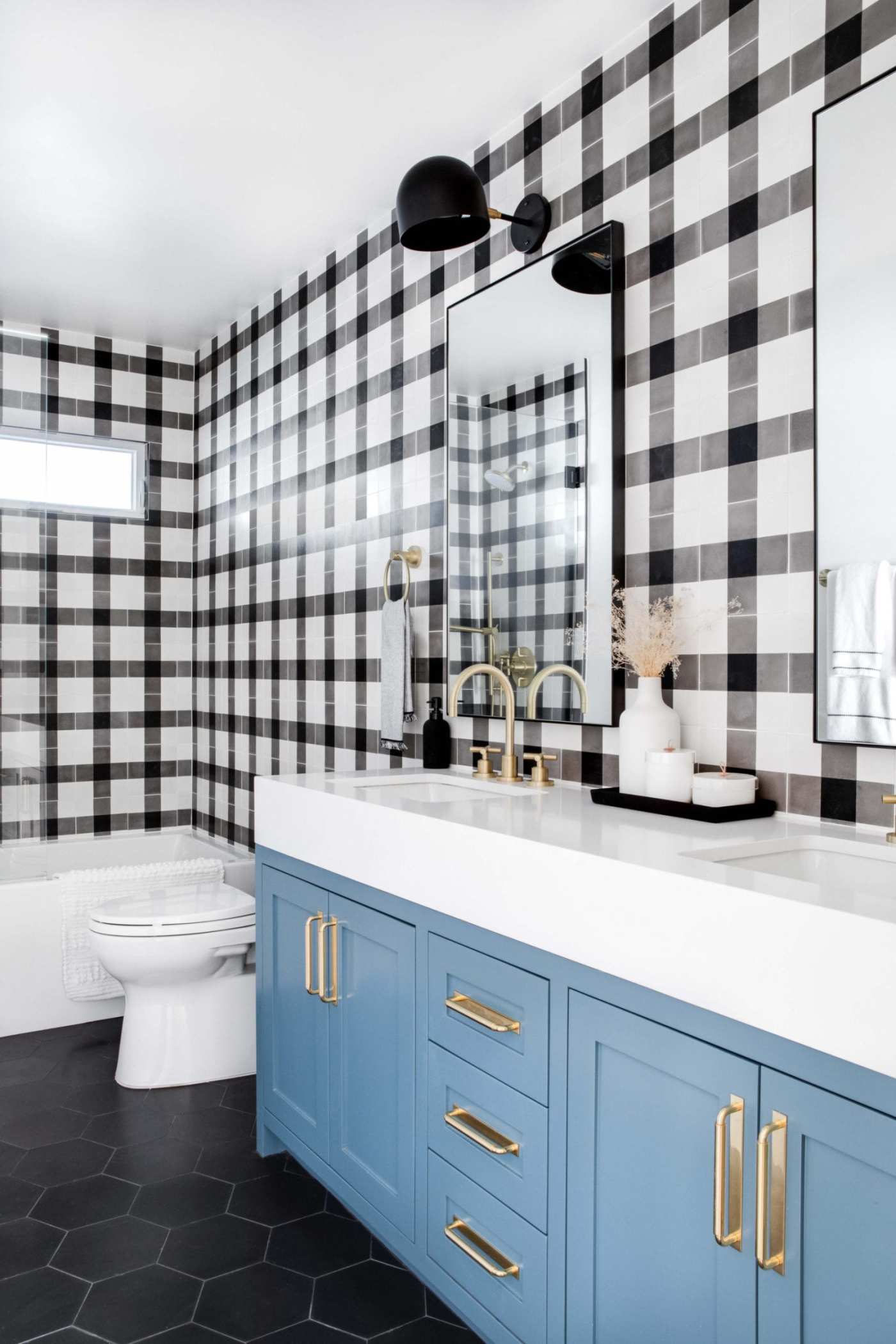 a bathroom with a black and white checkered wall.