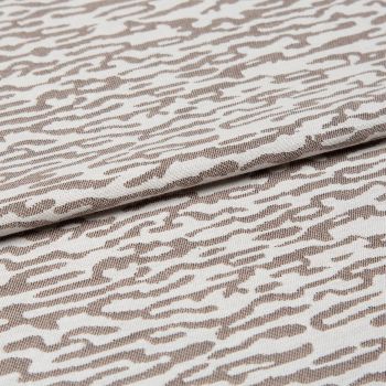 Decorative woven fabric with white and light beige abstract zebra-like pattern, tightly woven and folded across the center; lying as a layered textile sample in a close-up, evenly lit shot.