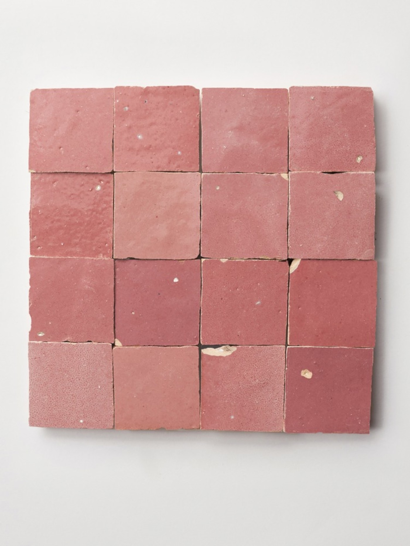 square pink tiles on a white surface.