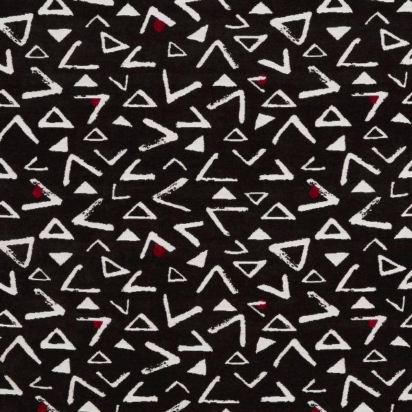 Black fabric patterned with irregular white triangles and chevron-like marks, and occasional small red teardrops; pattern repeats across the flat textile, creating a high-contrast abstract design.