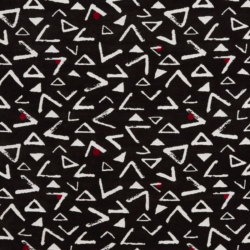 Black fabric patterned with irregular white triangles and chevron-like marks, and occasional small red teardrops; pattern repeats across the flat textile, creating a high-contrast abstract design.