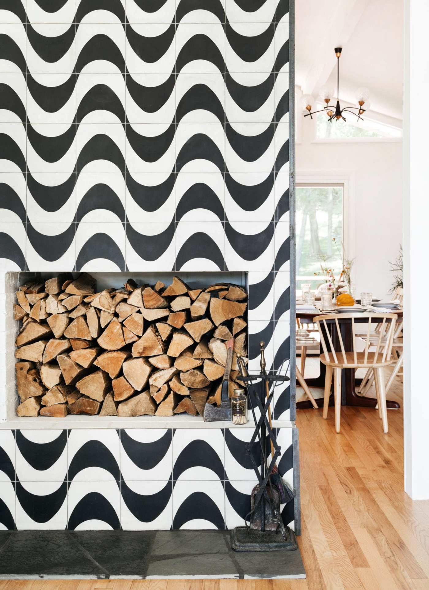 a tiled fireplace with a black and white wavy pattern.