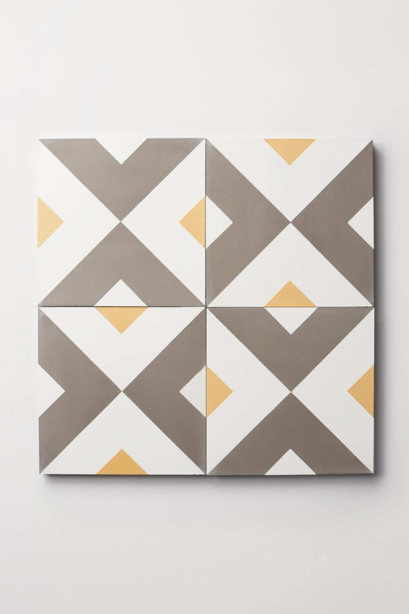 a set of tiles with yellow and grey geometric designs.