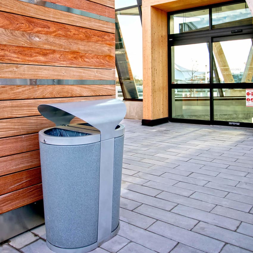 outdoor recycling and trash container at the entrance of a waterfront resort