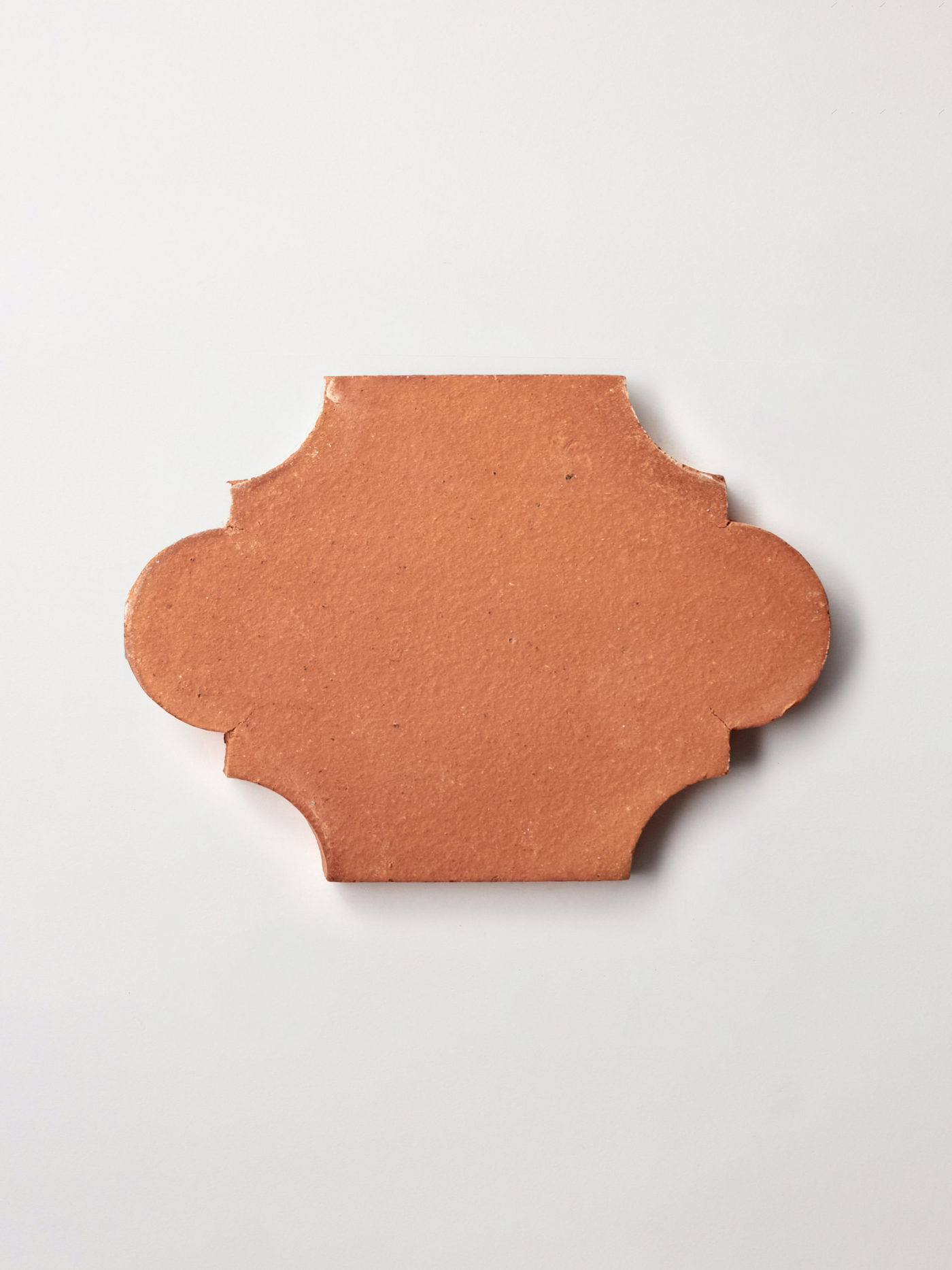 a red ornamental tile on a white background.