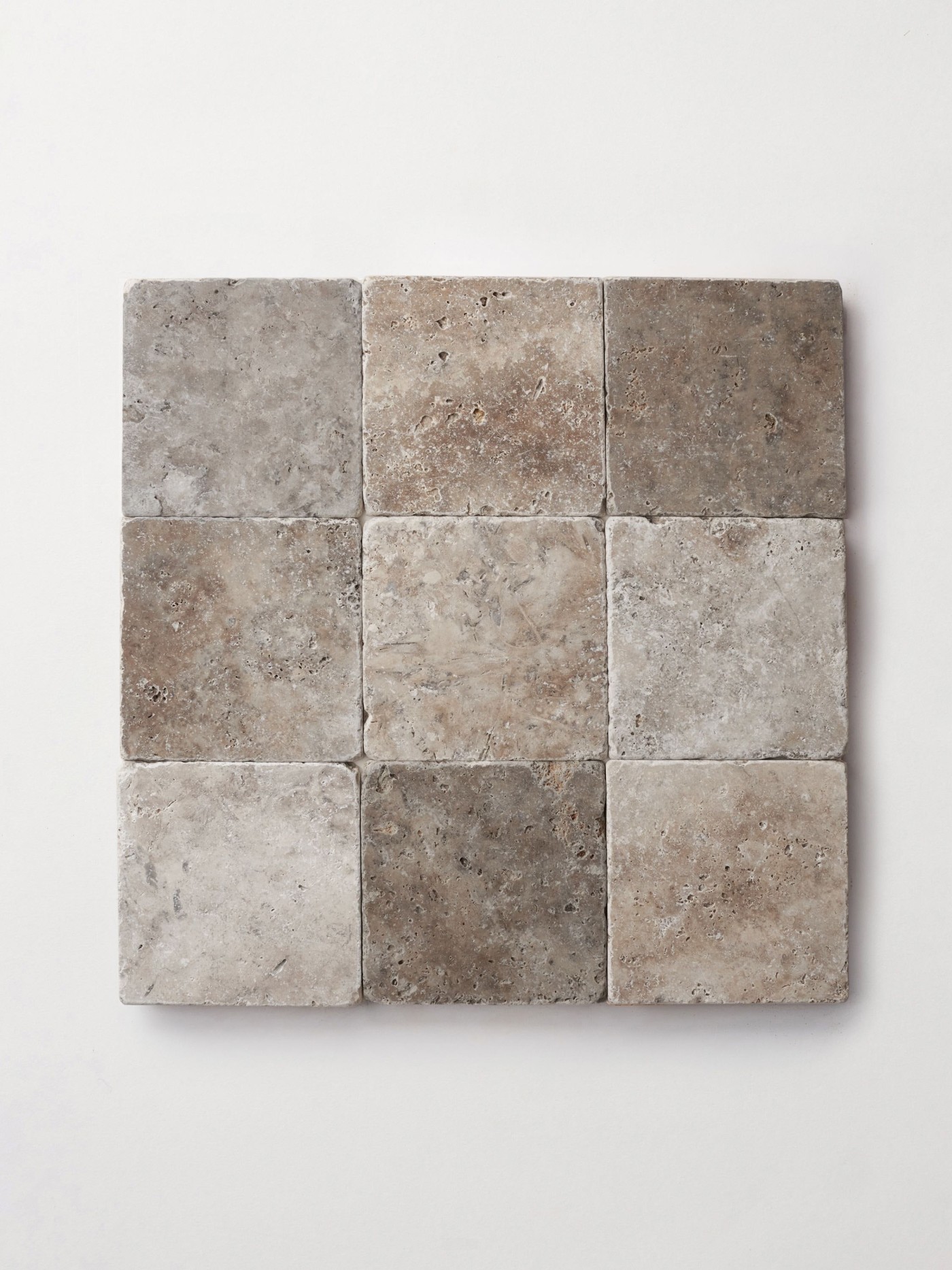 9 square natural stone tiles on a white surface.