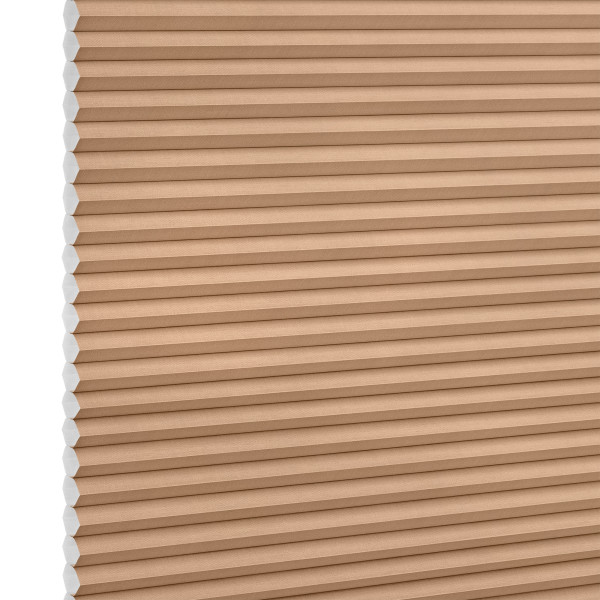 Beige honeycomb (cellular) blind with visible white cell ends at left, closed and blocking light; close-up product shot against a plain white background with even lighting.