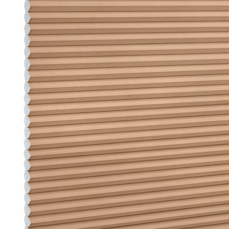 Beige honeycomb (cellular) blind with visible white cell ends at left, closed and blocking light; close-up product shot against a plain white background with even lighting.