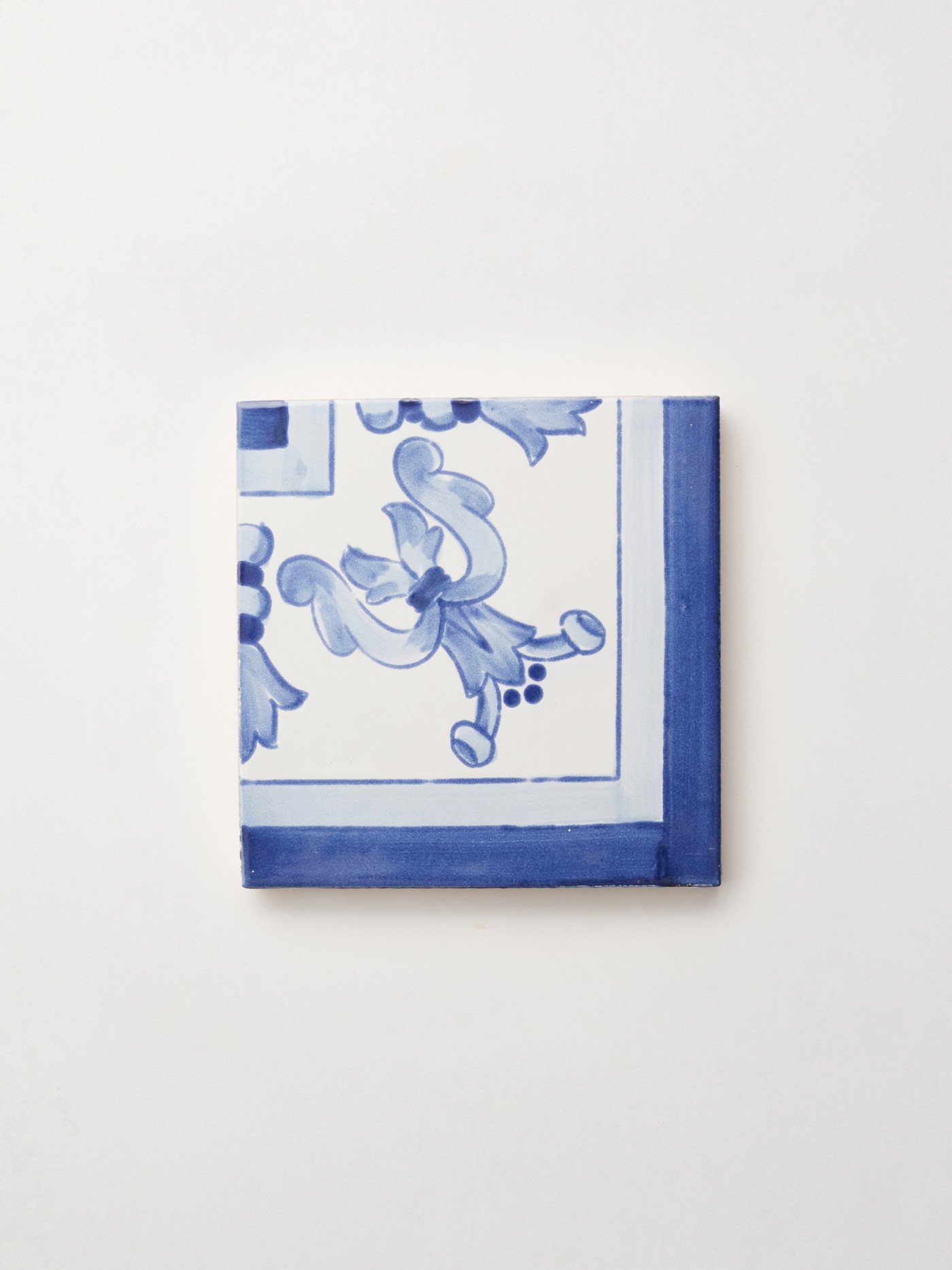 a blue and white tile on a white surface.