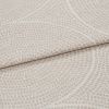Beige textured fabric with pebbleâ€‘like raised dots and subtle curved lines; folded horizontally across the frame; close-up studio shot showing layered upholstery material in even, soft lighting.