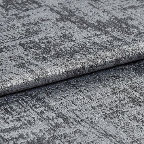 Textured metallic silver fabric folded and layered, its crushed, variegated pile shimmering and reflecting light; close-up studio view with soft lighting and a neutral background.