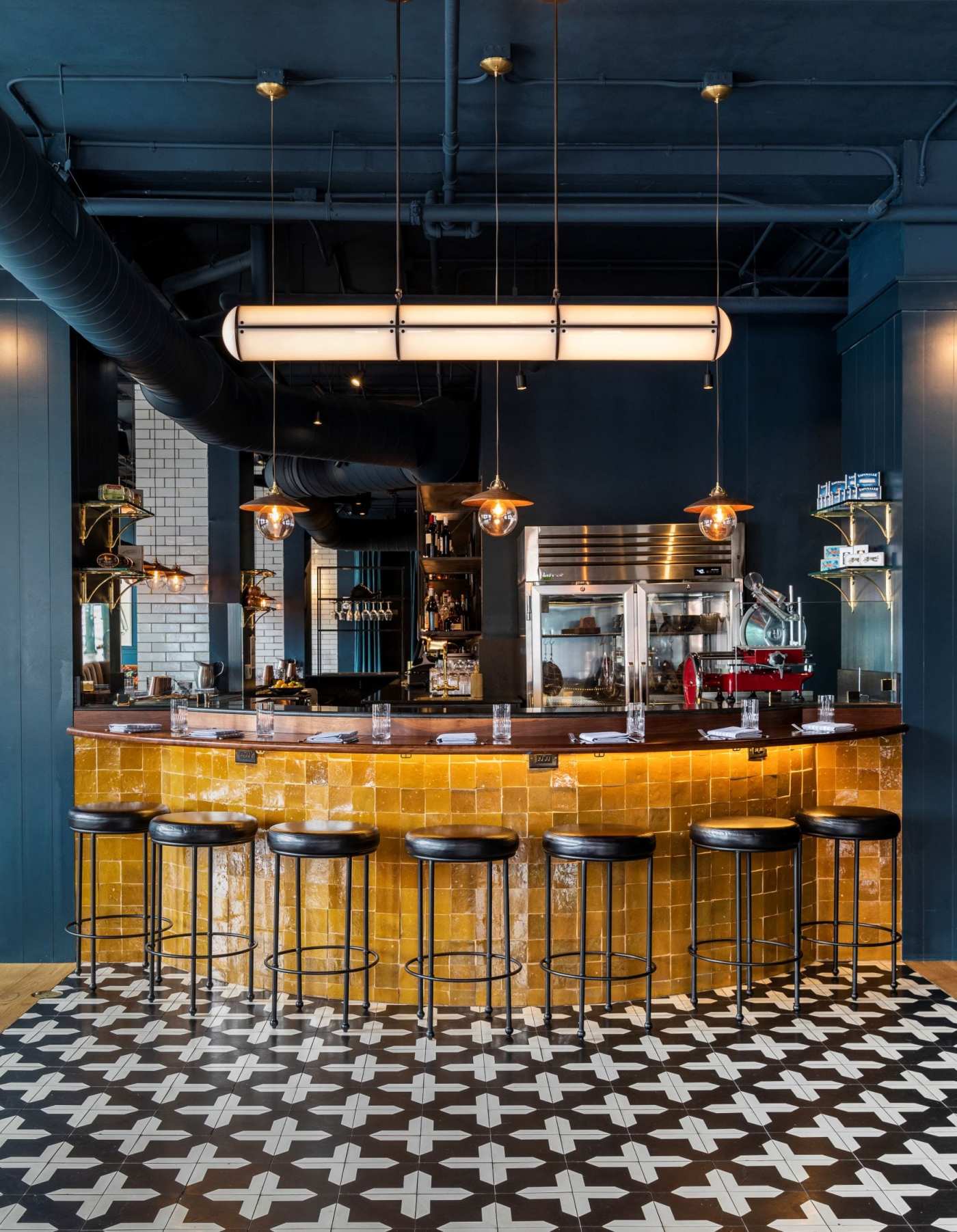 a black and white patterned tile floor in a restaurant.