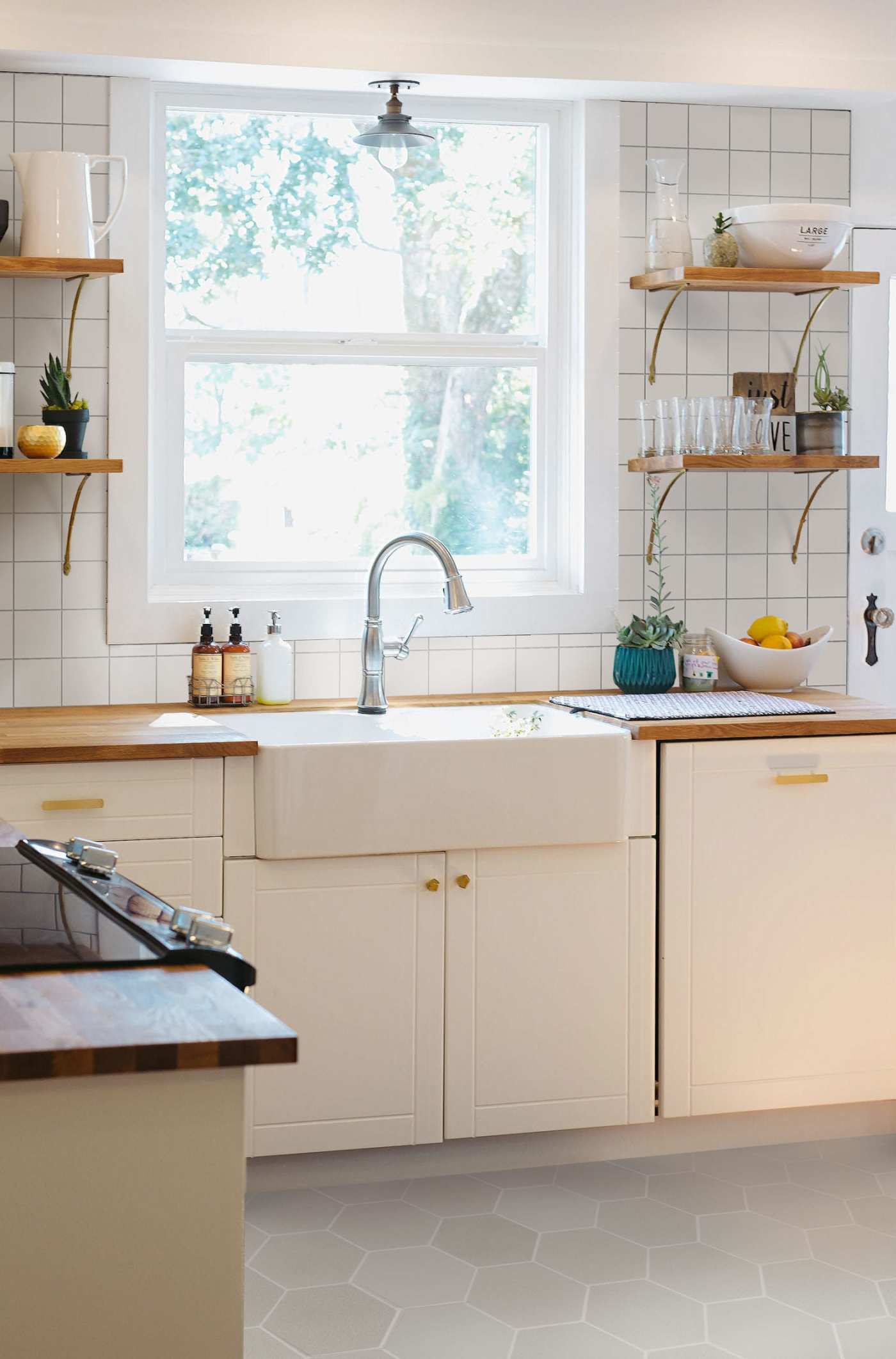 a white kitchen with white cabinets and a sink.