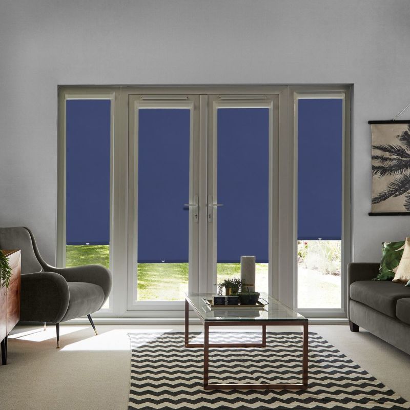 Blue roller blinds across central French doors and flanking tall windows, lowered nearly to the sill with narrow bottom gaps; blocking most view and filtering daylight into a living room.