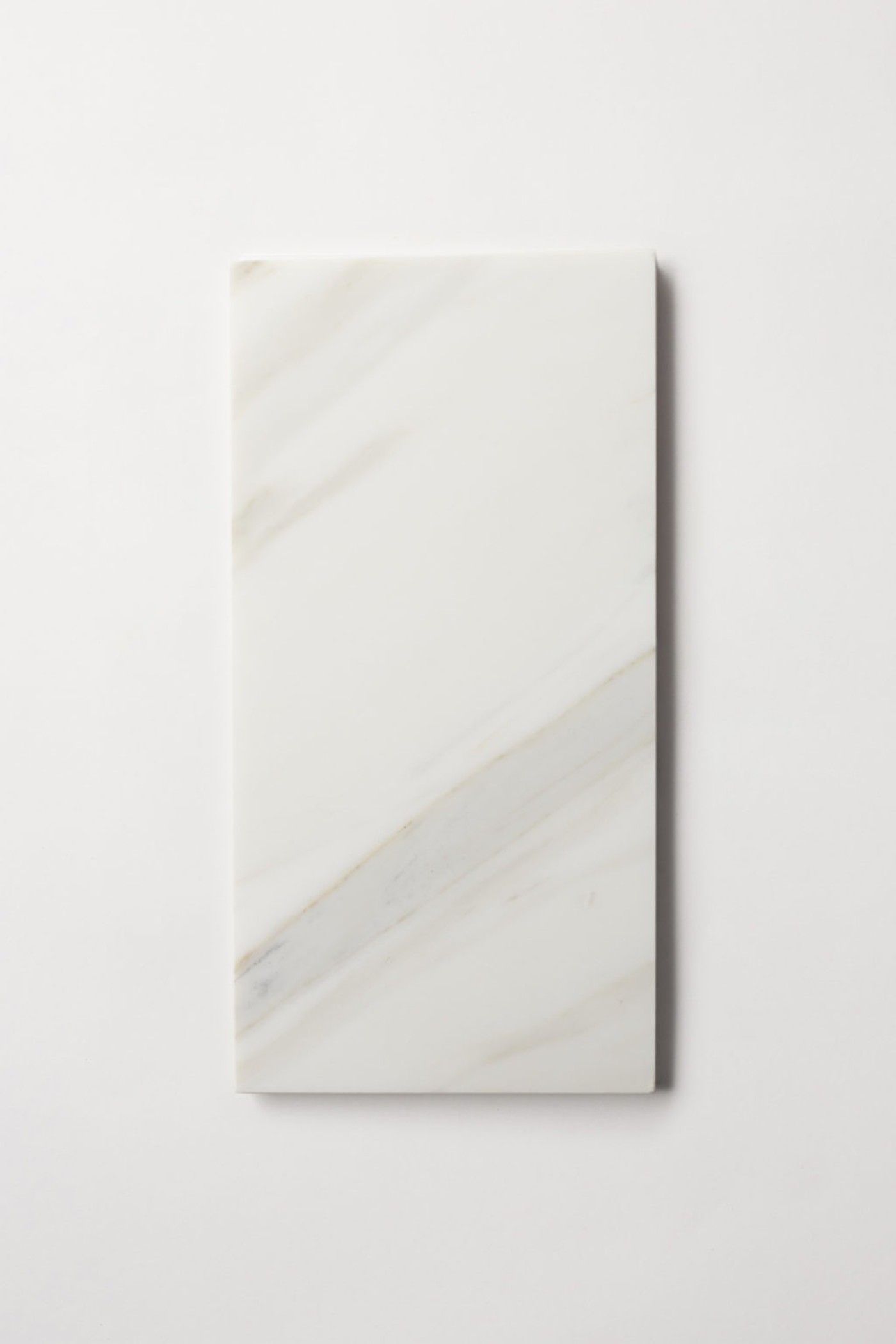 a white rectangle marble tile on a white surface.