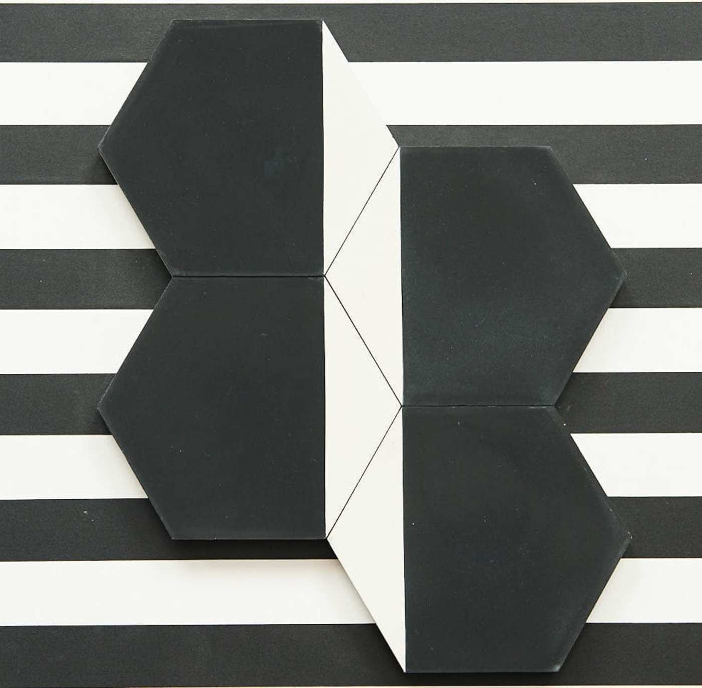 black and white hexagon tiles on a black and white striped background.