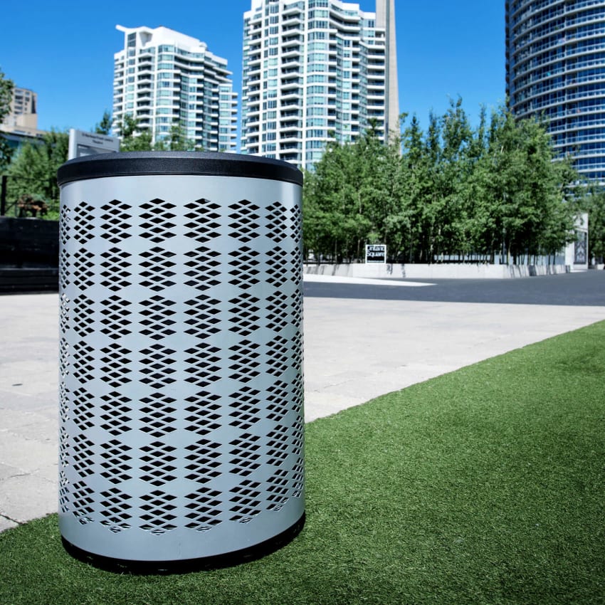 silver powder coated waste and recycling container with a black plastic lid in a city park