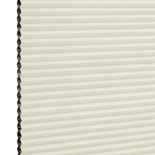 Cream cellular (honeycomb) blind with dark-lined cells visible on the left; closed into uniform horizontal pleats, filtering soft diffuse indoor light against a neutral background.