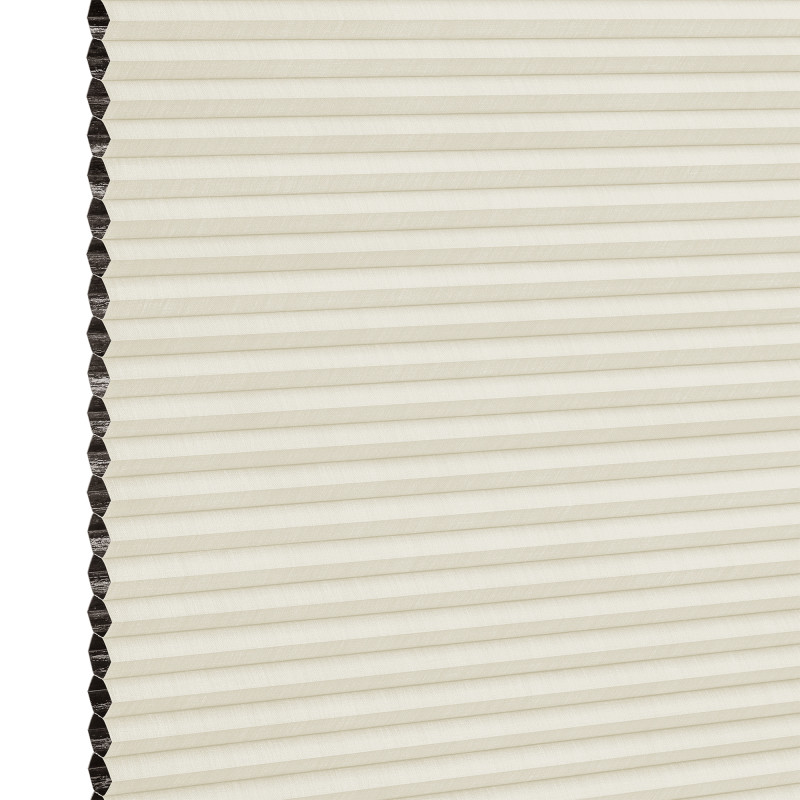 Cream cellular (honeycomb) blind with dark-lined cells visible on the left; closed into uniform horizontal pleats, filtering soft diffuse indoor light against a neutral background.