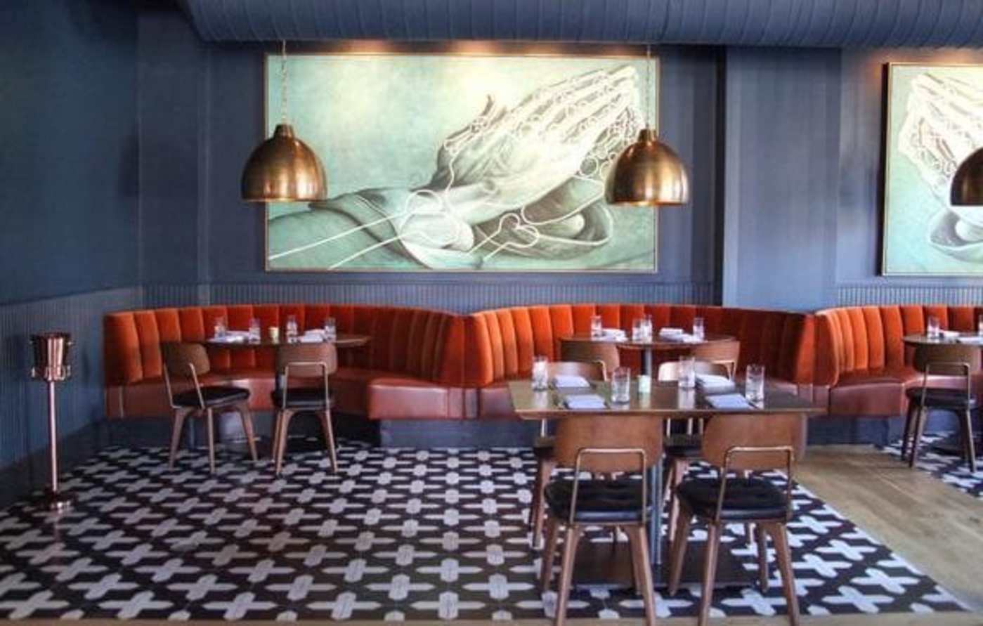 a restaurant with a checkered floor and a painting on the wall.