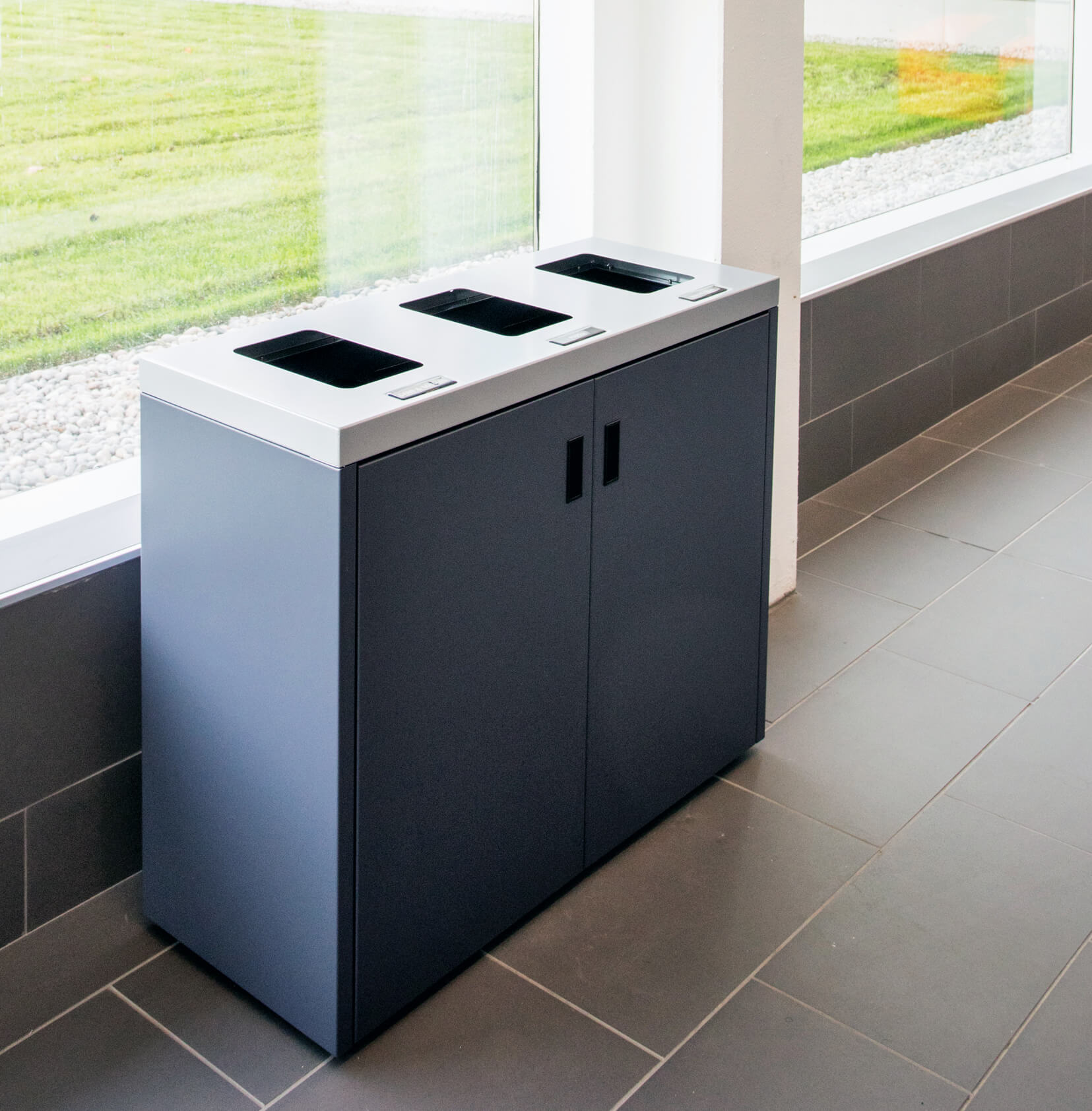 heavy duty steel recycling paper and waste container with flat lid and hinged front doors in a hospital hallway