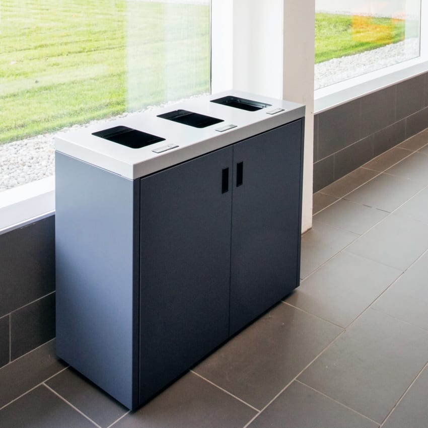 heavy duty steel recycling paper and waste container with flat lid and hinged front doors in a hospital hallway