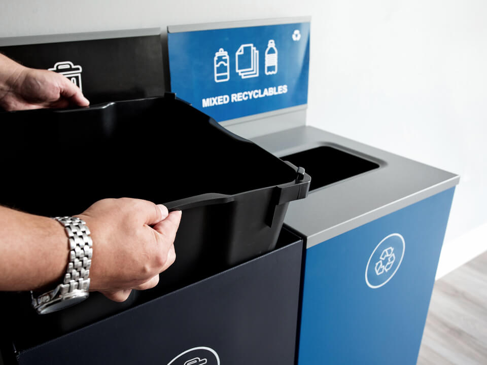 durable steel waste and recycling containers with sign frames and signs with the liner being lifted out to service the bin