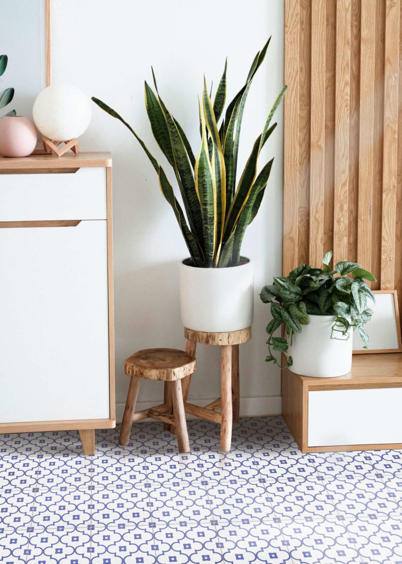 a room with a blue and white tiled floor and a wooden cabinet.