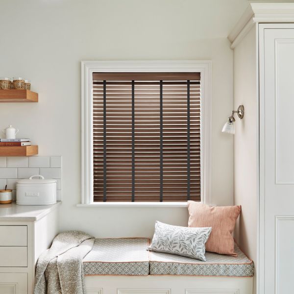 Brown wooden horizontal blinds with dark vertical tapes, fitted in a central window; closed, filtering daylight; cozy kitchen bench nook with cushions, pale walls, shelving and a bread box.
BREAD
THE PIG
TASTING ROME