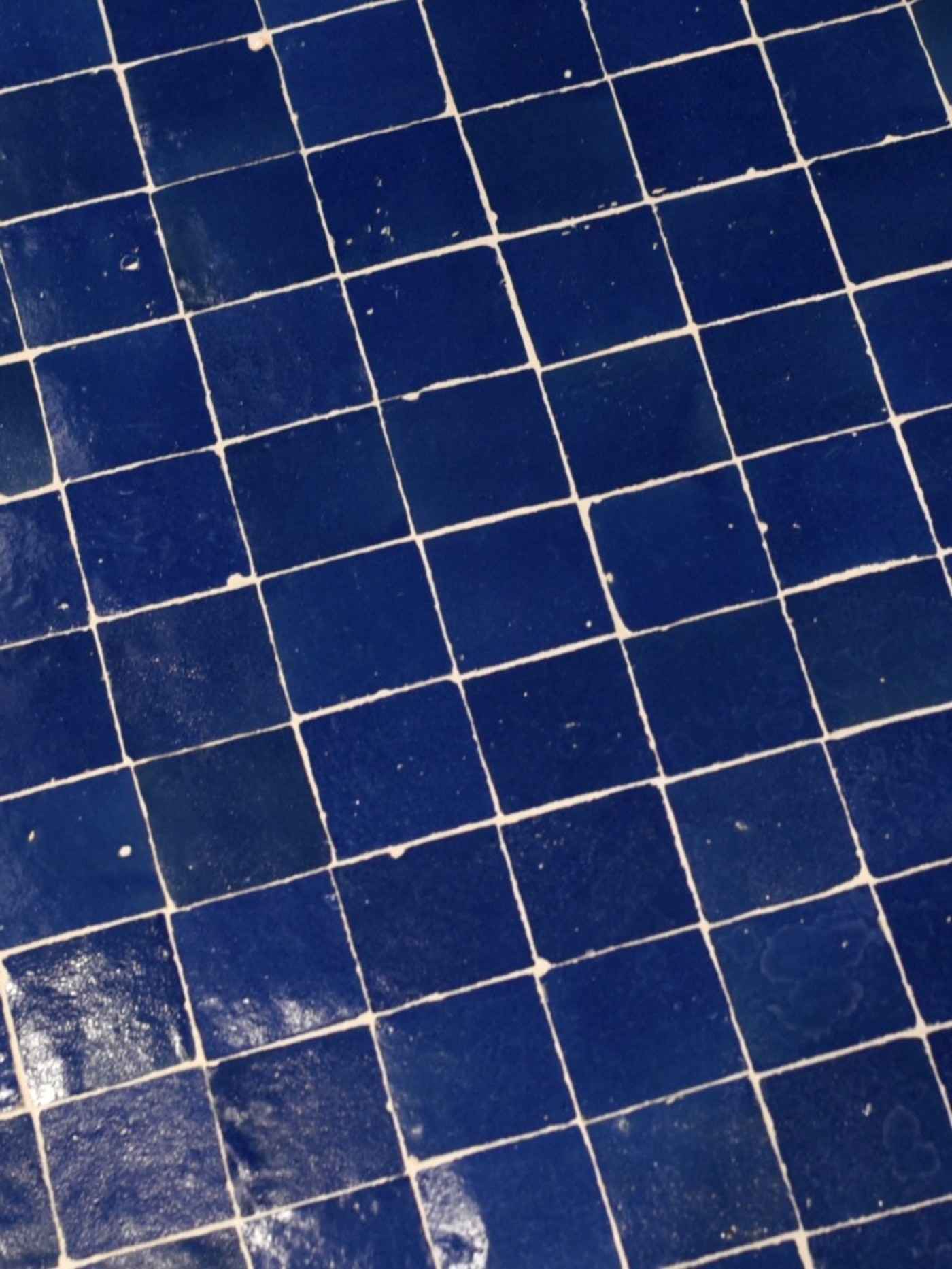 a blue tiled floor in a bathroom.