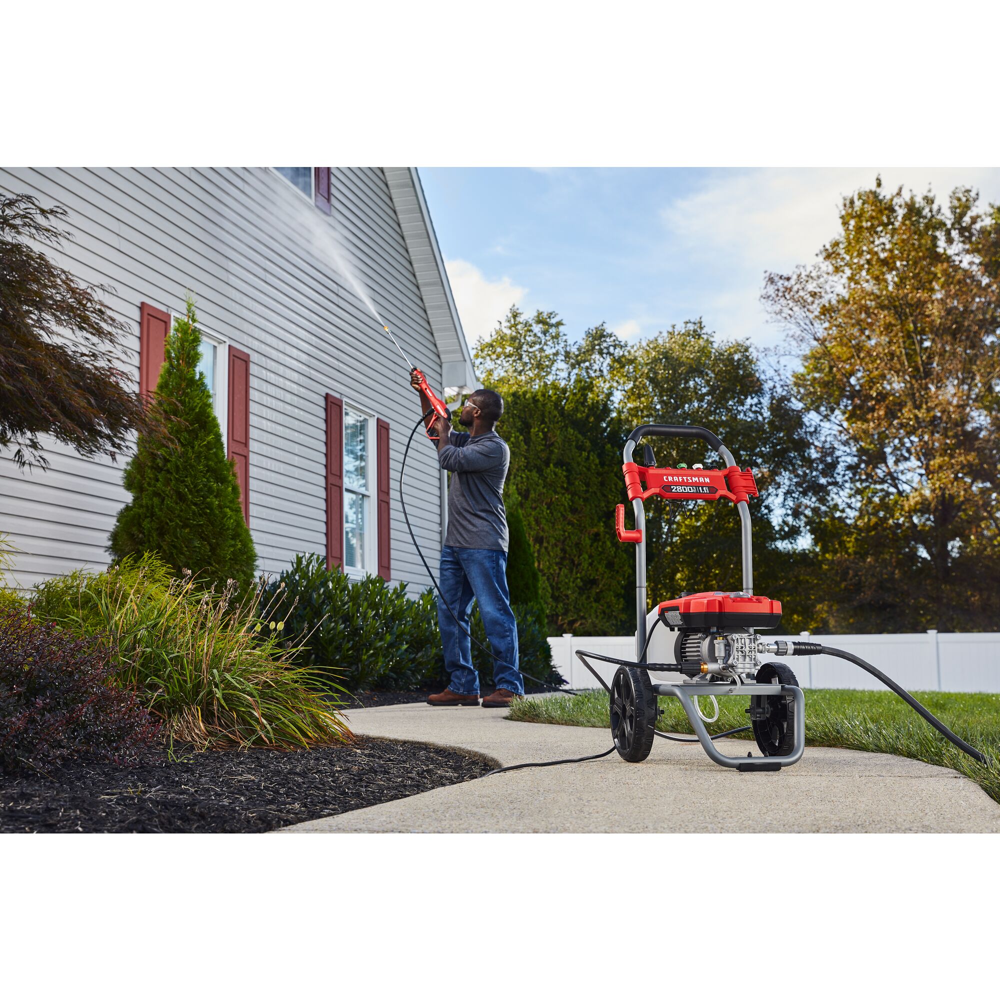 CRAFTSMAN 2800 Pressure Washer pressure washing second story of home with shrubs and fence