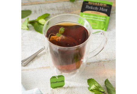 Glass mug of Perfectly Mint Tea with tea bag and foil packet