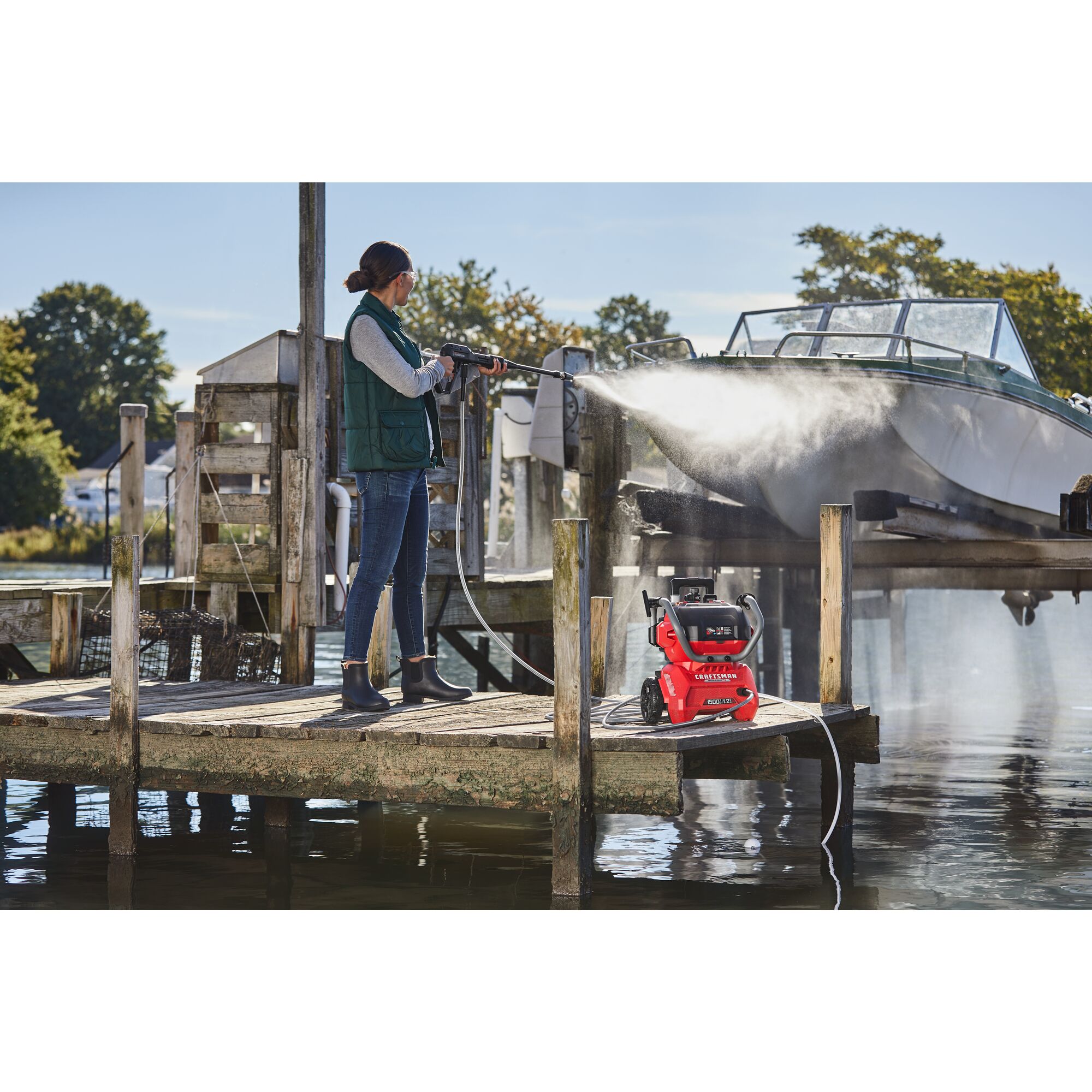 CRAFTSMAN 1500 PSI Pressure Washer washing a raised boat at pier