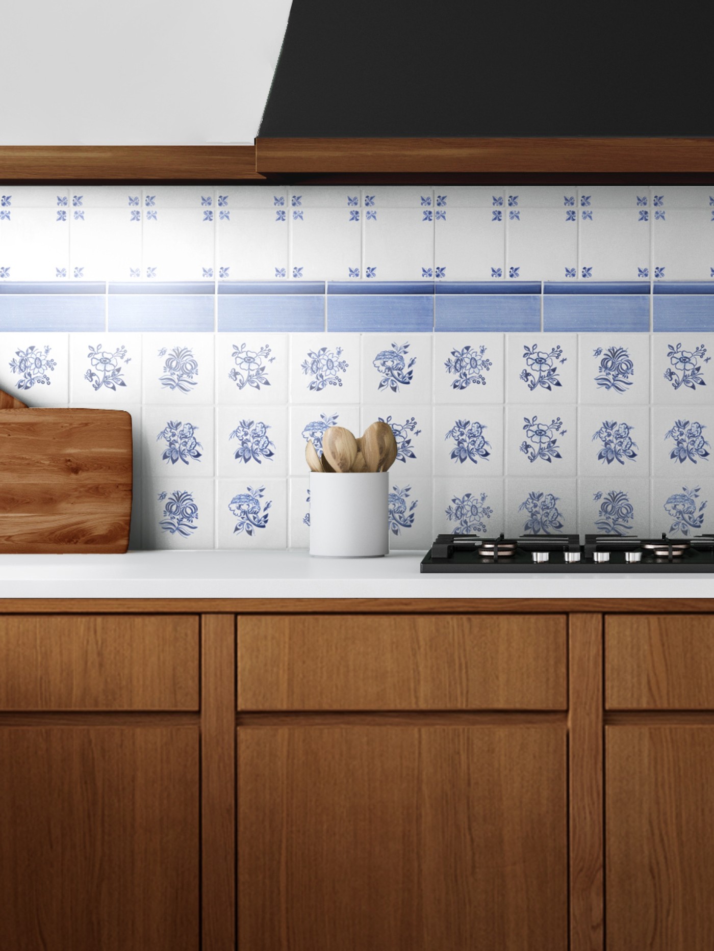 a blue and white tiled stove backsplash in a kitchen with wooden cabinets.