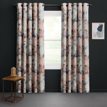 Grommet-top watercolor-patterned curtains, full-length and hung on a metal rod, parted slightly to expose a bright window; dark-painted wall, small wood side table with glass lamp and framed abstract art.