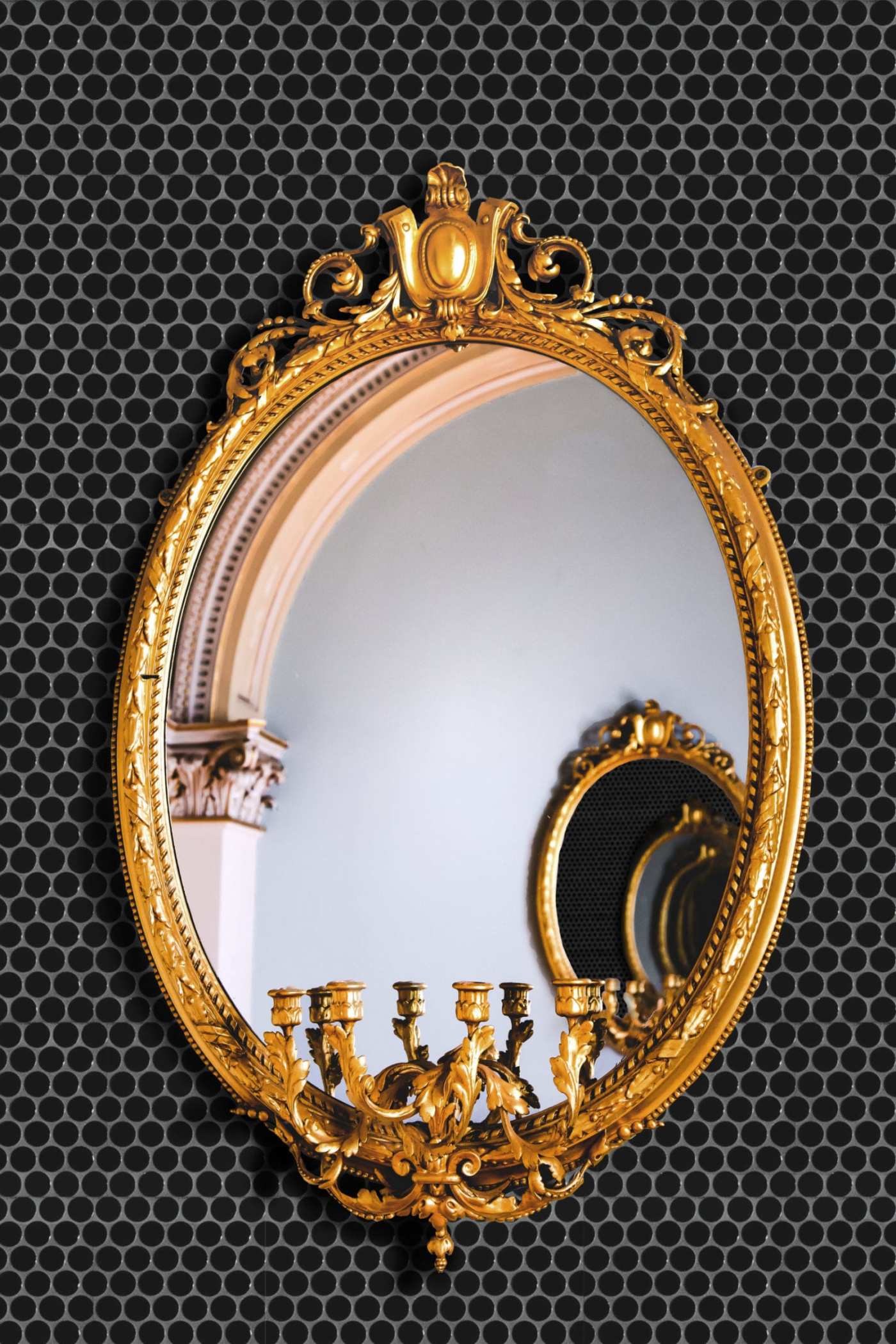 an ornate gold mirror on a black background.