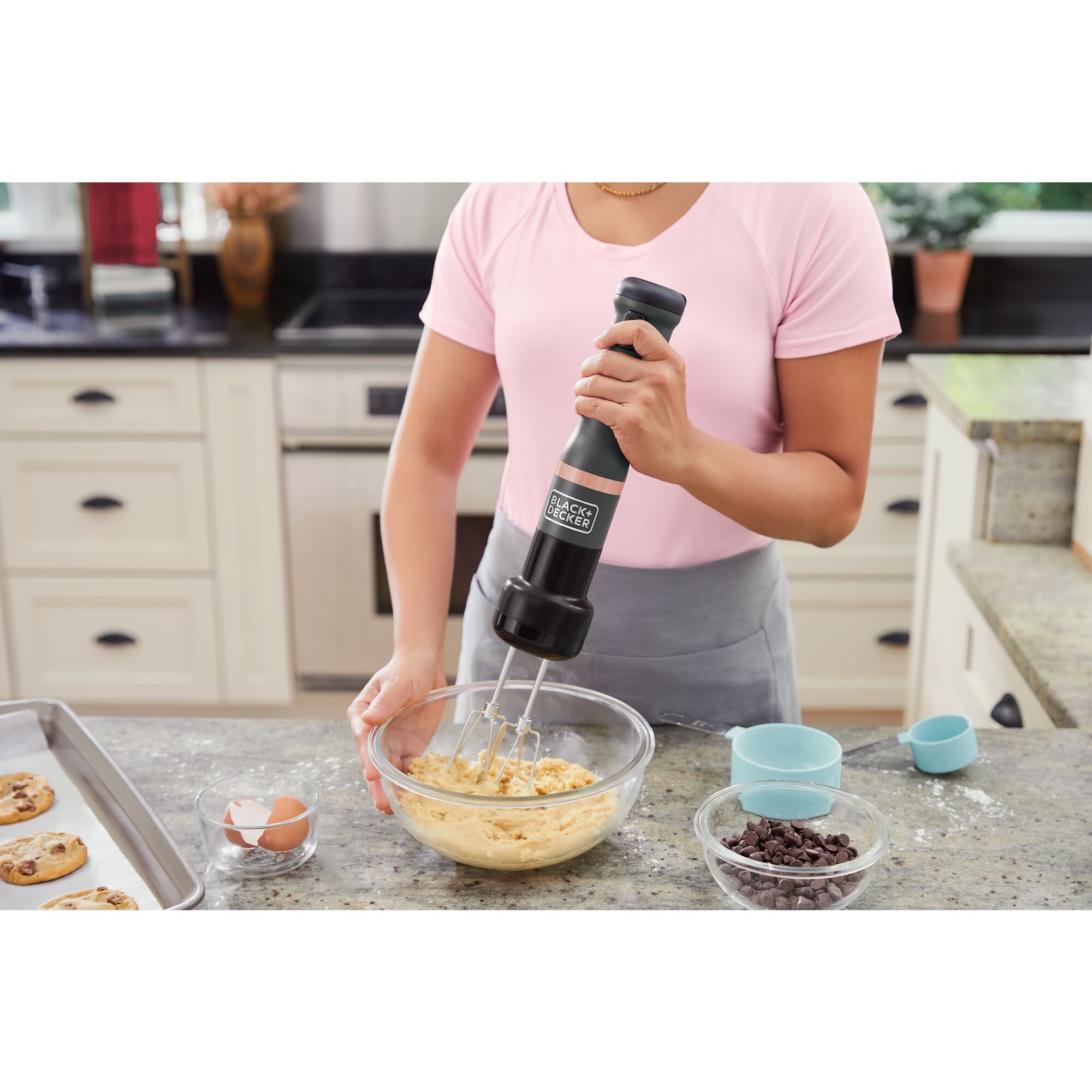 Talent using  BLACK+DECKER kitchen wand red wand with whisk attachment to make cookies