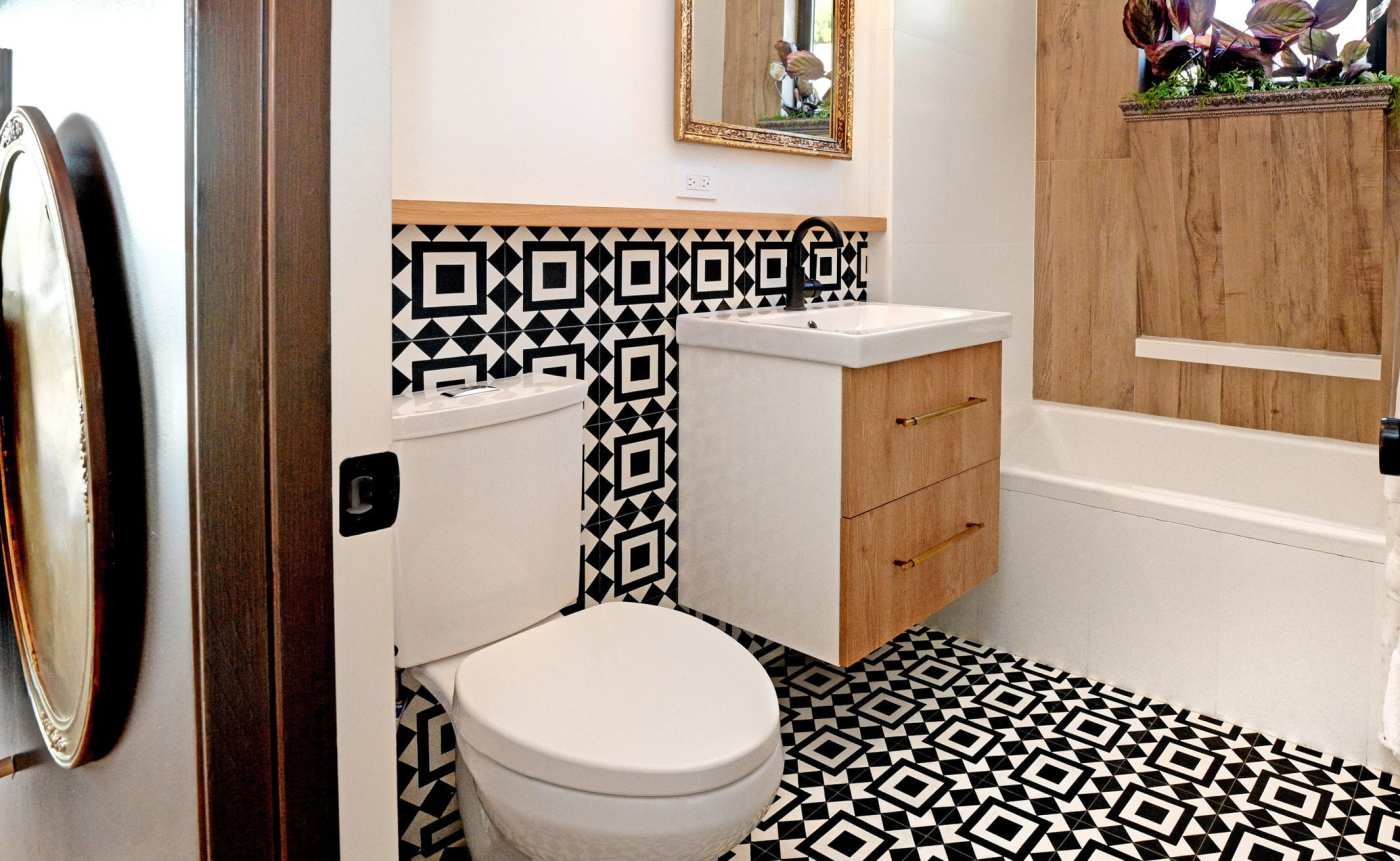 a bathroom with a black and white tiled floor.