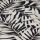 A folded decorative fabric with cream palm-leaf print on a black background; the layers overlap, emphasizing texture and weave, shown in a close-up under soft, even lighting.