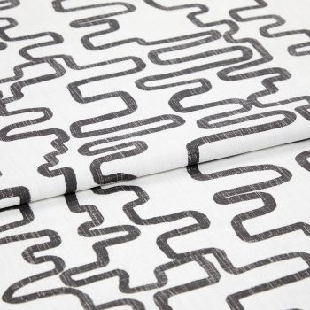 White woven fabric printed with charcoal, distressed looping-rectangle pattern, folded to show overlapping layers; studio close-up with even soft lighting and neutral background.