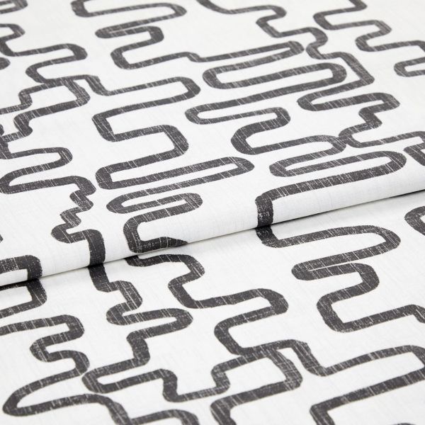 White woven fabric printed with charcoal, distressed looping-rectangle pattern, folded to show overlapping layers; studio close-up with even soft lighting and neutral background.