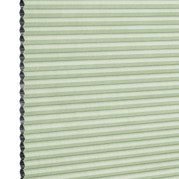 Cellular (honeycomb) blind, pale green with visible black cell edges — closed, pleated and covering the frame — close-up product view with even lighting and a neutral background.