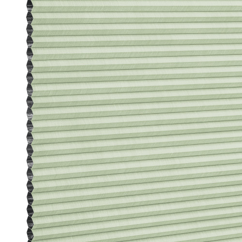 Cellular (honeycomb) blind, pale green with visible black cell edges â€” closed, pleated and covering the frame â€” close-up product view with even lighting and a neutral background.