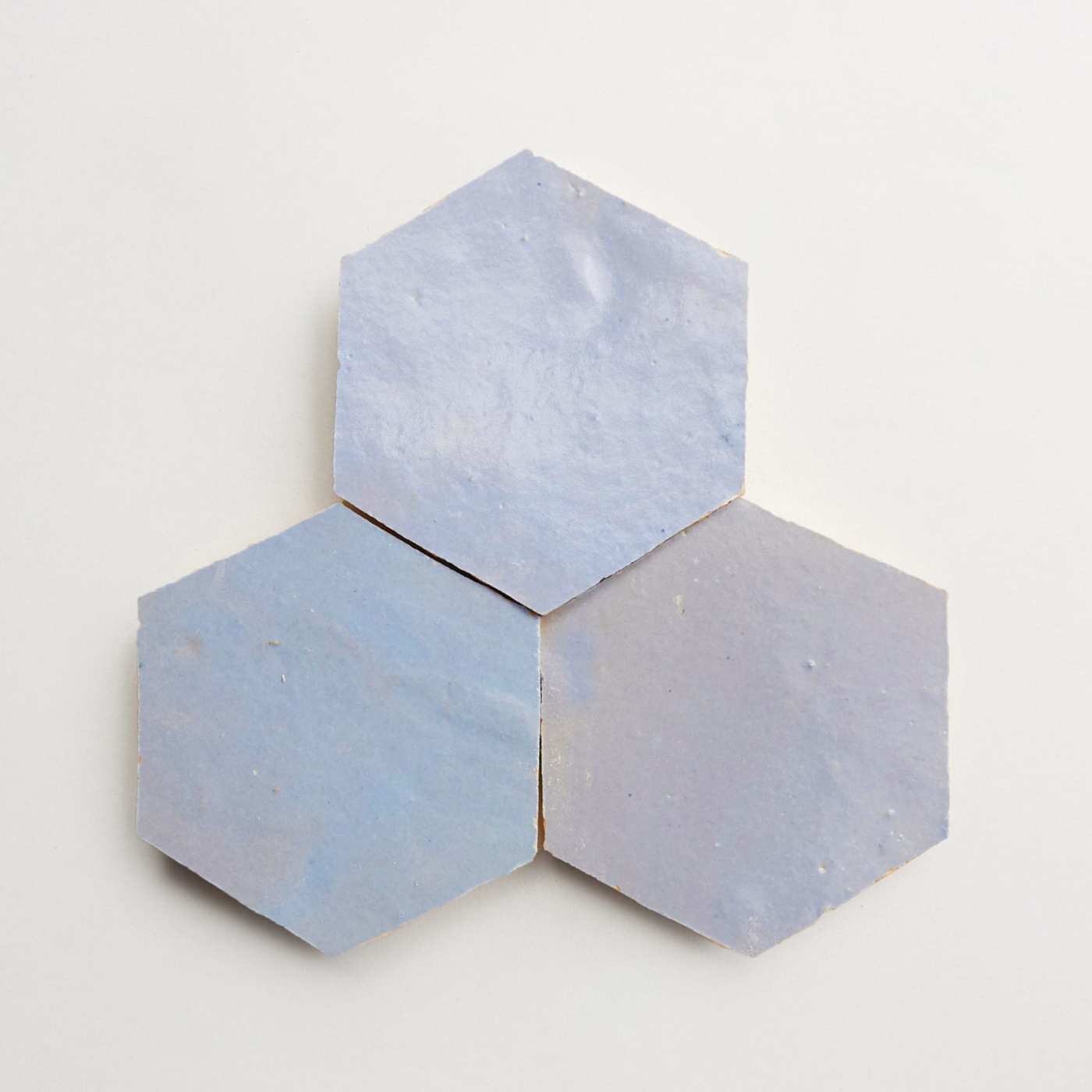 three blue hexagonal tiles on a white surface.