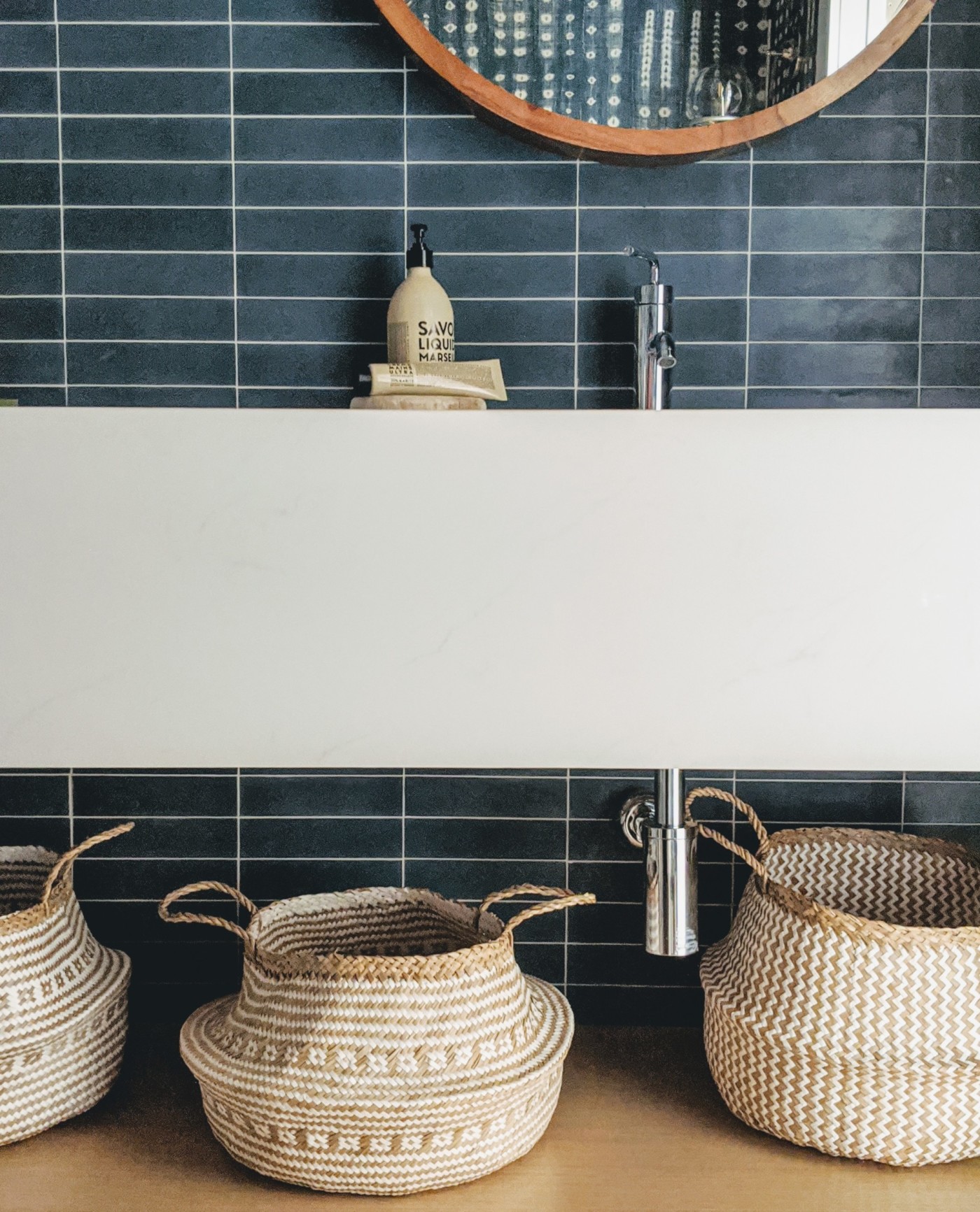 wicker baskets and a mirror in a bathroom.