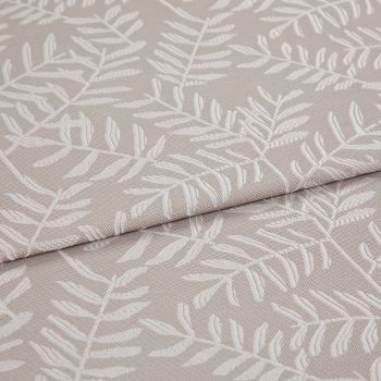 Beige jacquard fabric with raised white fern motif; folded and overlapped; close-up of an upholstery/curtain sample on a flat surface under soft, neutral lighting.