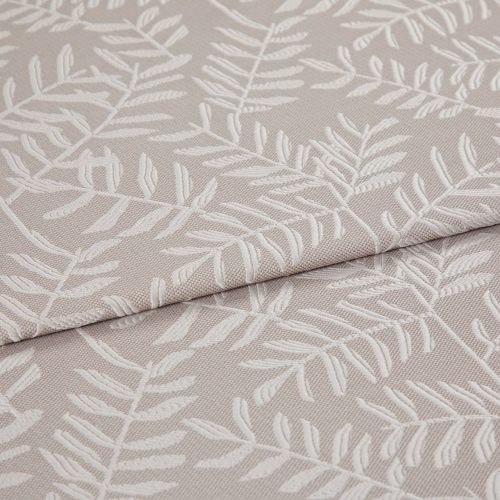 Beige jacquard fabric with raised white fern motif; folded and overlapped; close-up of an upholstery/curtain sample on a flat surface under soft, neutral lighting.